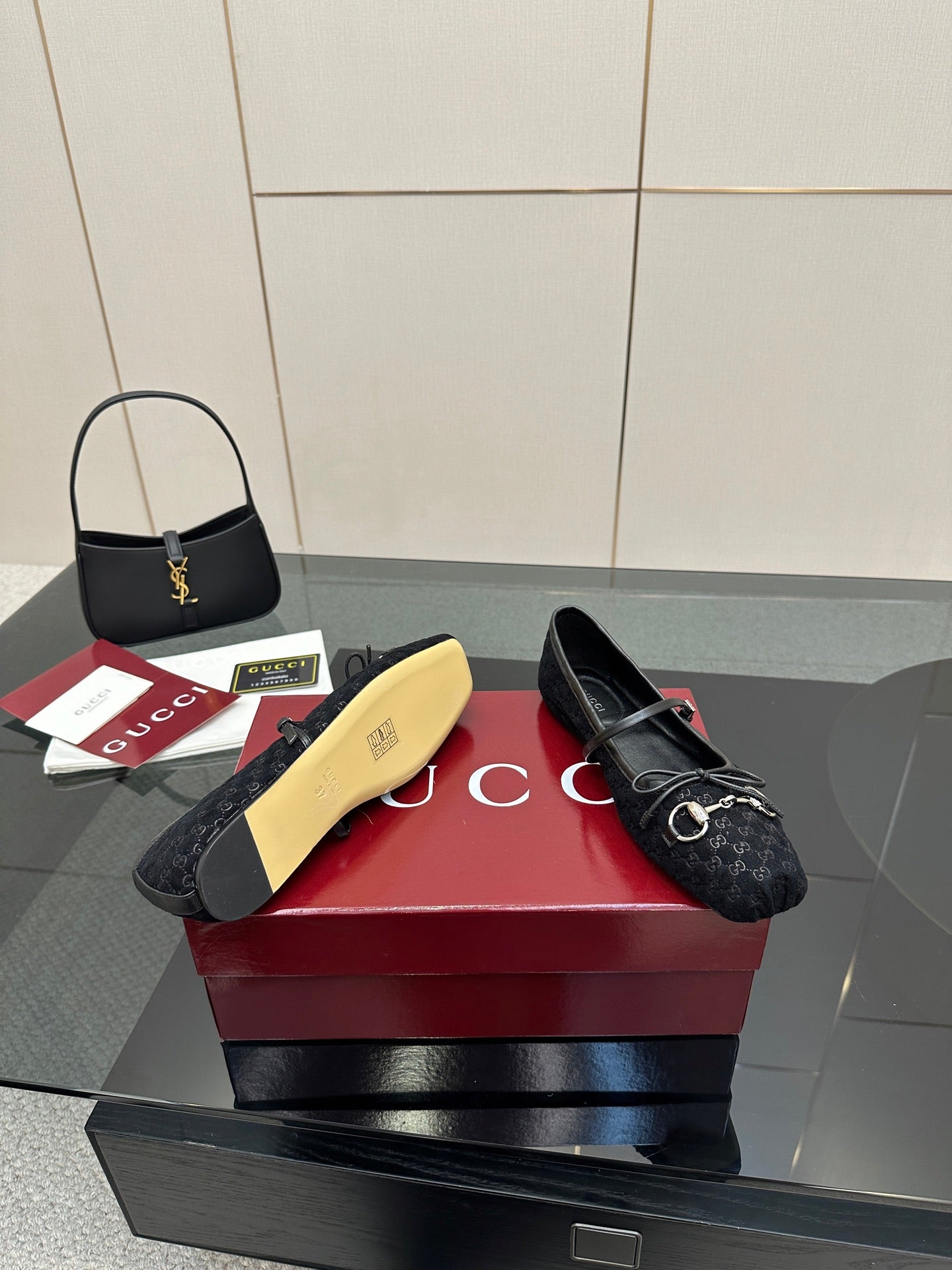 Gucci black loafers with patterned upper and metal bit detail, sole visible