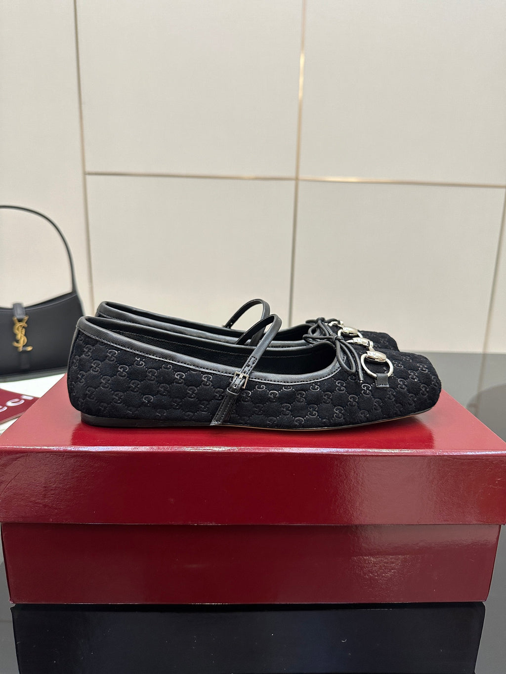 Gucci black ballerina-style flats with metal chain detail and patterned upper