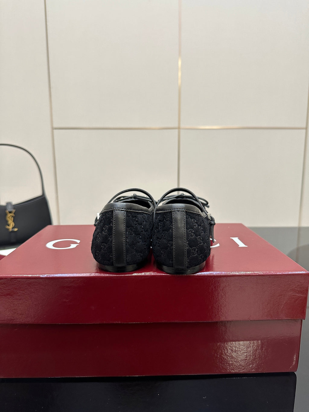Gucci black loafers, rear view showing low heel and patterned fabric texture