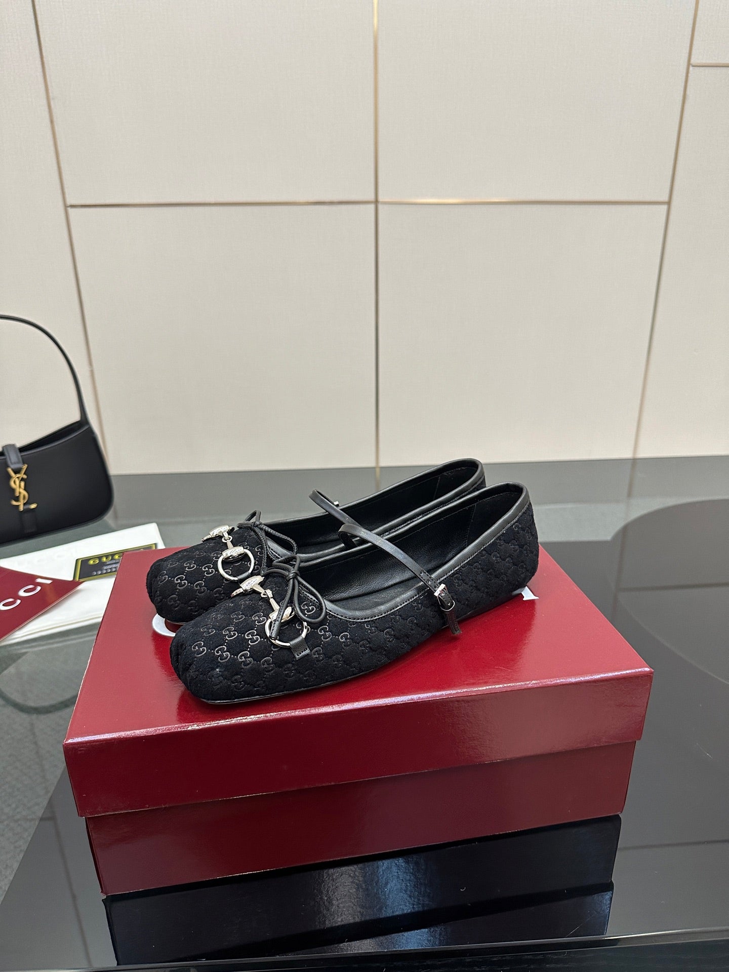 Gucci black loafer with strap and Horsebit-style metal detail, patterned texture