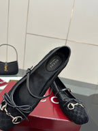 Gucci black flat loafer pair, side view with metal chain hardware and patterned upper