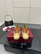 Gucci ladies woven loafers in yellow with brown trim, front view pair on box
