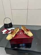 Gucci ladies woven loafers in yellow with brown trim, angled view pair on box