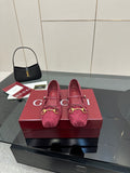 Gucci ladies pink textured loafers with gold-tone bit detail, shown as a pair.