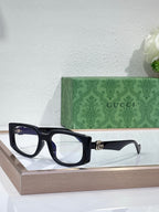 Gucci glasses with dark navy rectangular frames and clear lenses