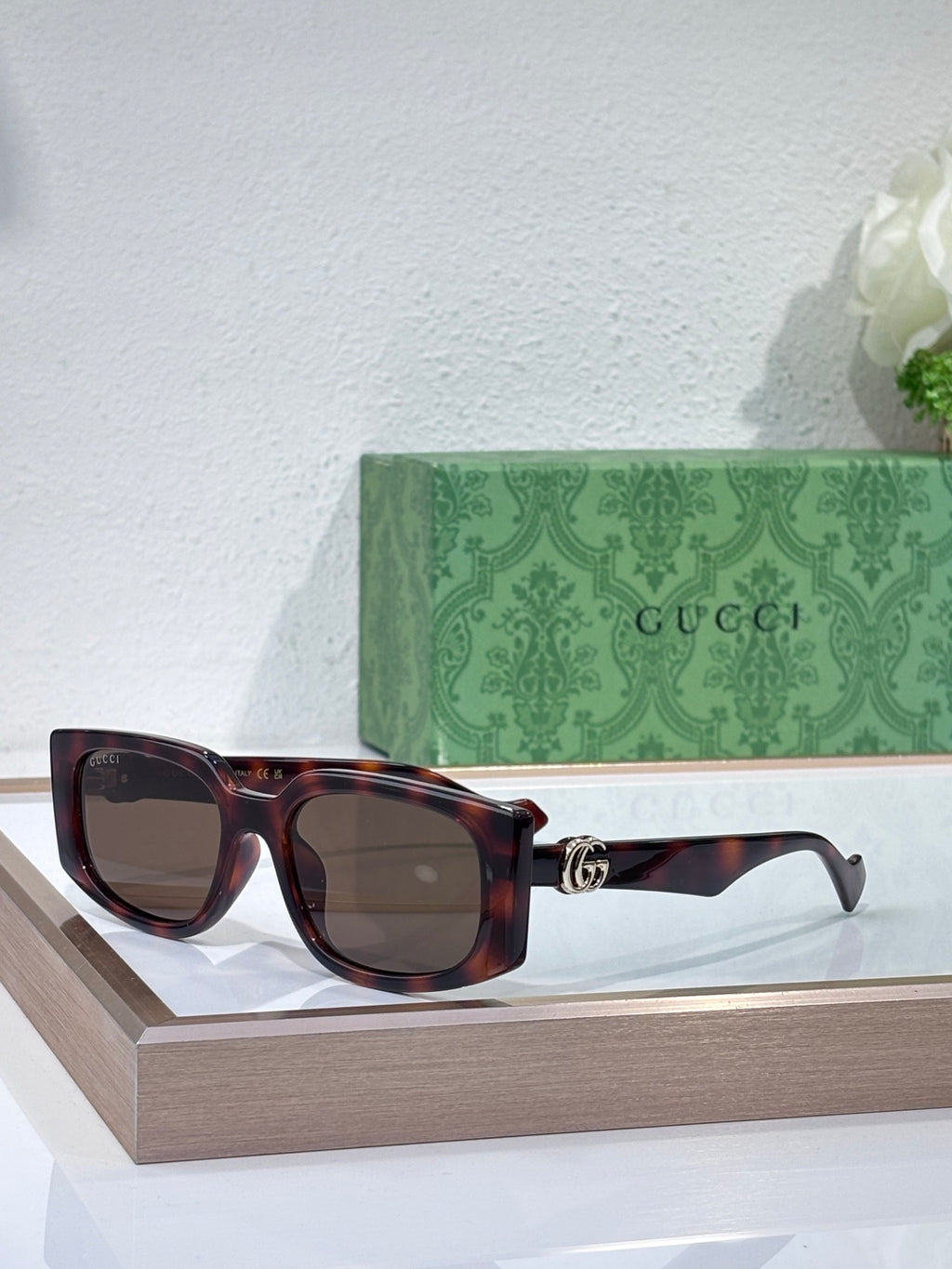 Gucci glasses with dark tortoiseshell frames and dark tinted lenses
