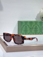 Gucci glasses with tortoiseshell frames and dark lenses