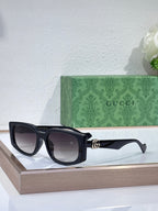 Gucci glasses with black square frames and dark tinted lenses