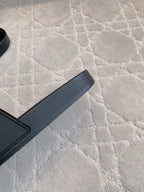 Black rubber slide sandal strap and footbed edge, side detail