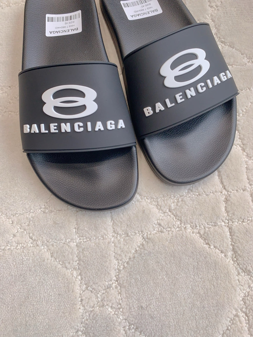 Balenciaga slide sandals, black, close-up of front logo strap