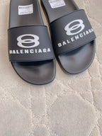 Balenciaga slide sandals, black, close-up of front logo strap