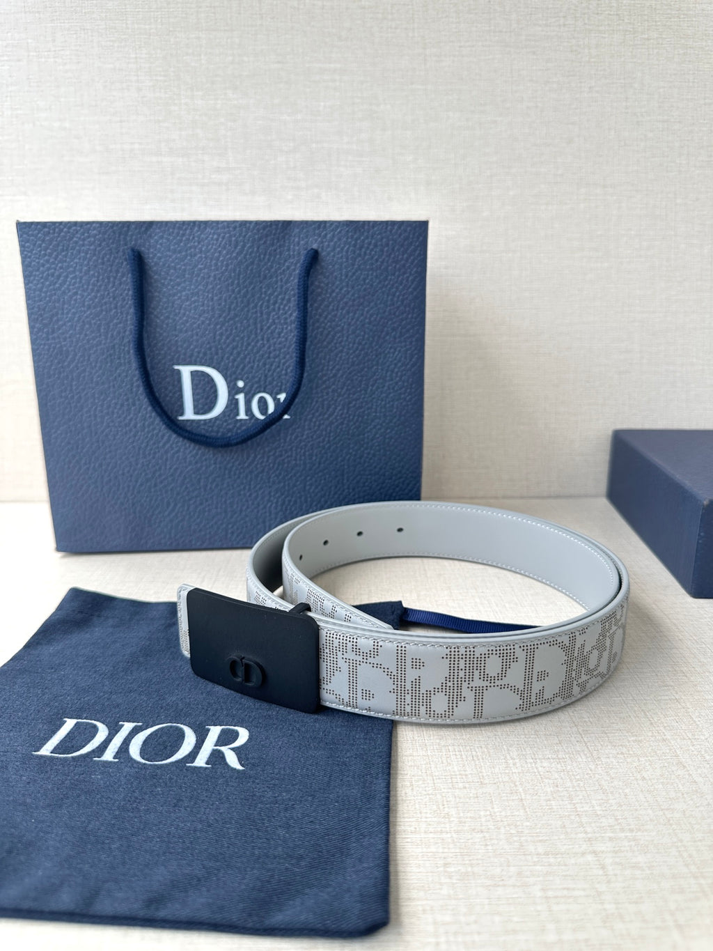Dior belt coiled with light gray pattern strap and navy square buckle
