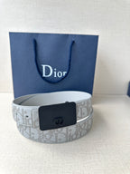 Dior belt with light gray monogram strap and dark navy buckle on display