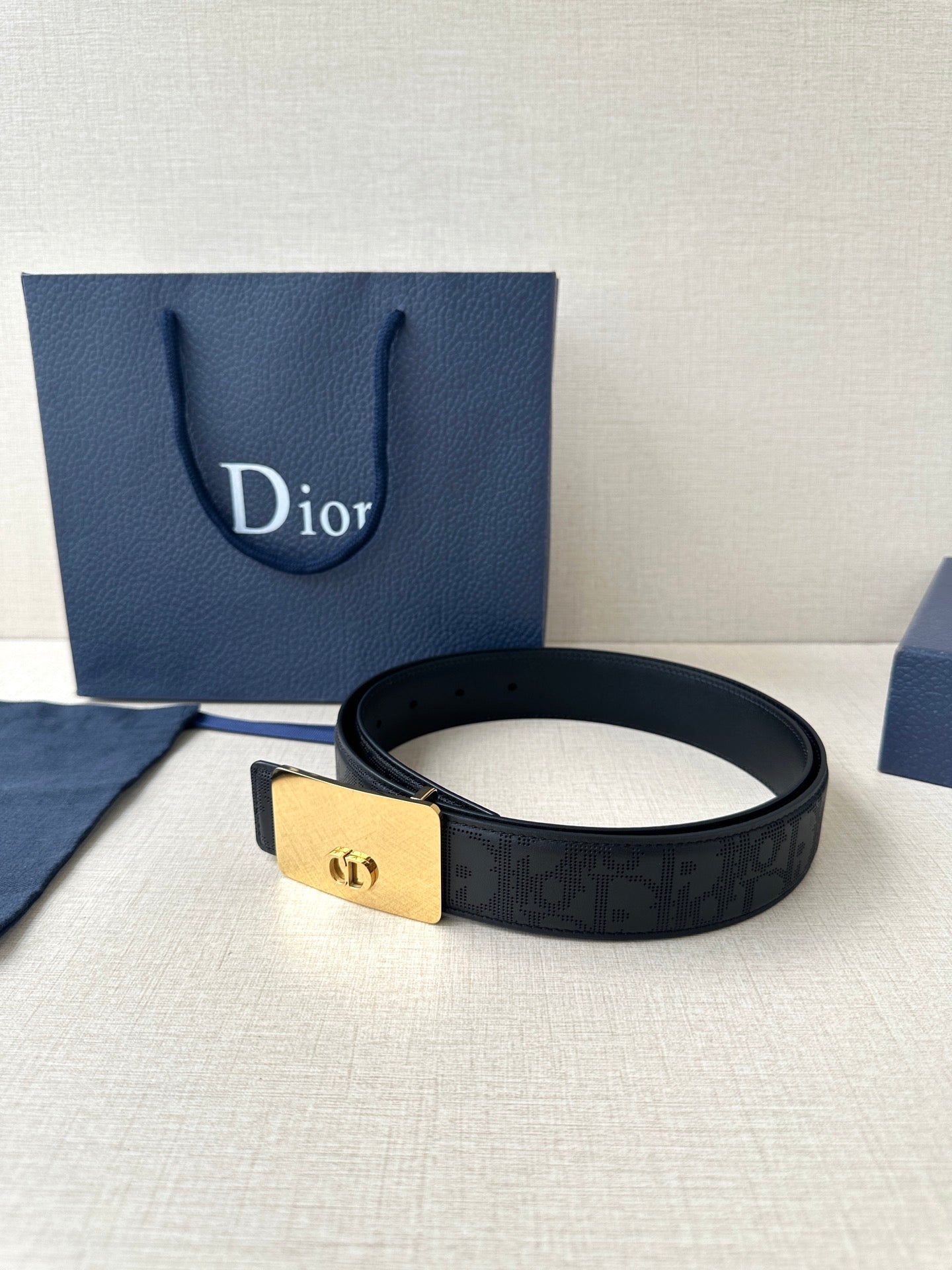 Dior belt in dark navy with embossed pattern and gold-toned buckle