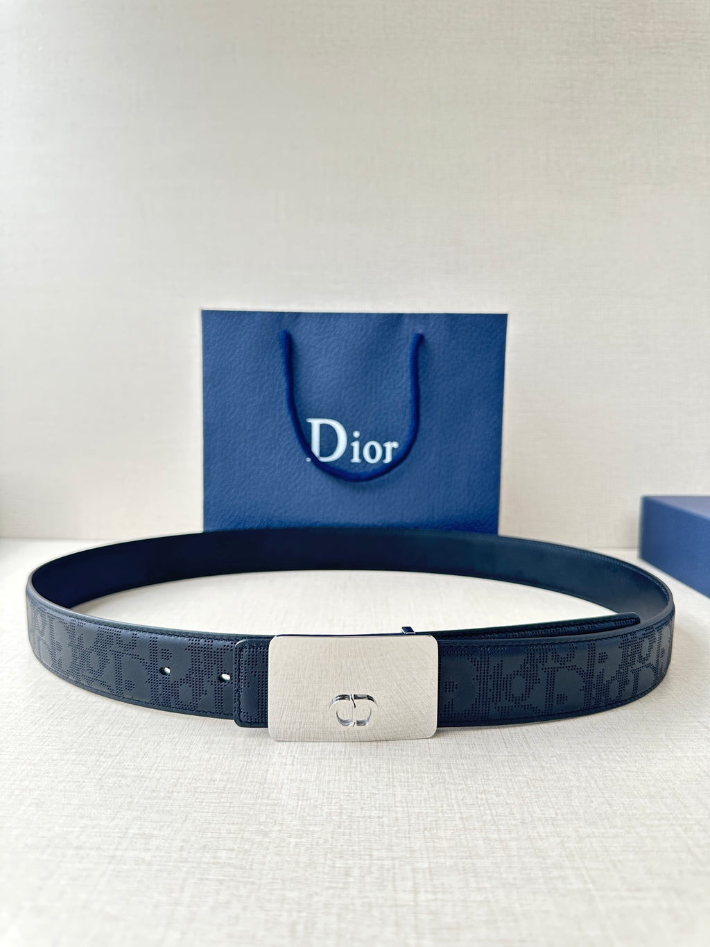 Dior belt in dark navy textured leather with metal buckle and punched holes
