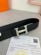 Black Hermes belt with silver H buckle and keeper on textured leather