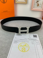 Black Hermes belt with silver H buckle on textured leather strap