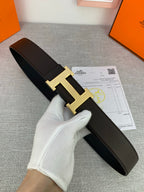 Dark leather belt with gold-tone H buckle and matching keeper strap
