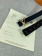 Black monogram belt with gold-tone square buckle, with receipt beneath