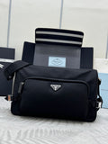 Prada dark crossbody bag with front flap and silver logo emblem