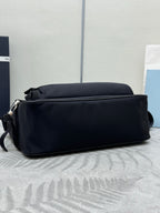 Prada dark crossbody bag with rounded back profile and strap loops