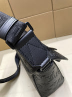 Louis Vuitton dark monogram crossbody bag with strap attachment and embossed leather texture