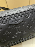 Louis Vuitton dark monogram crossbody bag close-up of embossed pattern and zipper pull