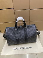 Louis Vuitton monogram duffel bag with top handles and side straps, dark gray