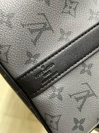 Monogram handbag leather strap close-up with embossed logo tag