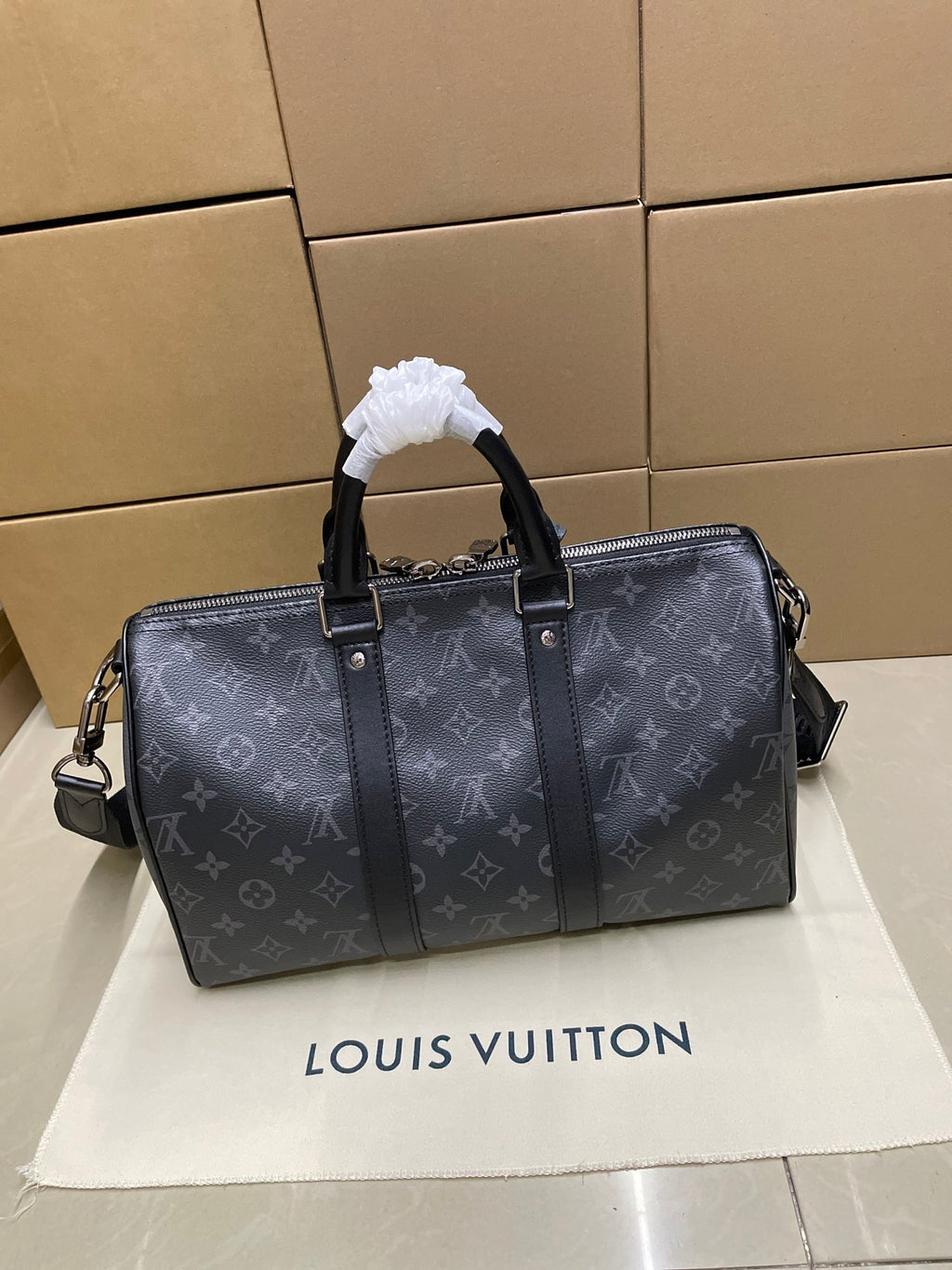 Louis Vuitton monogram duffel bag with top handle and shoulder strap, dark gray