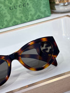 Gucci tortoiseshell sunglasses close-up on lenses and frame curve