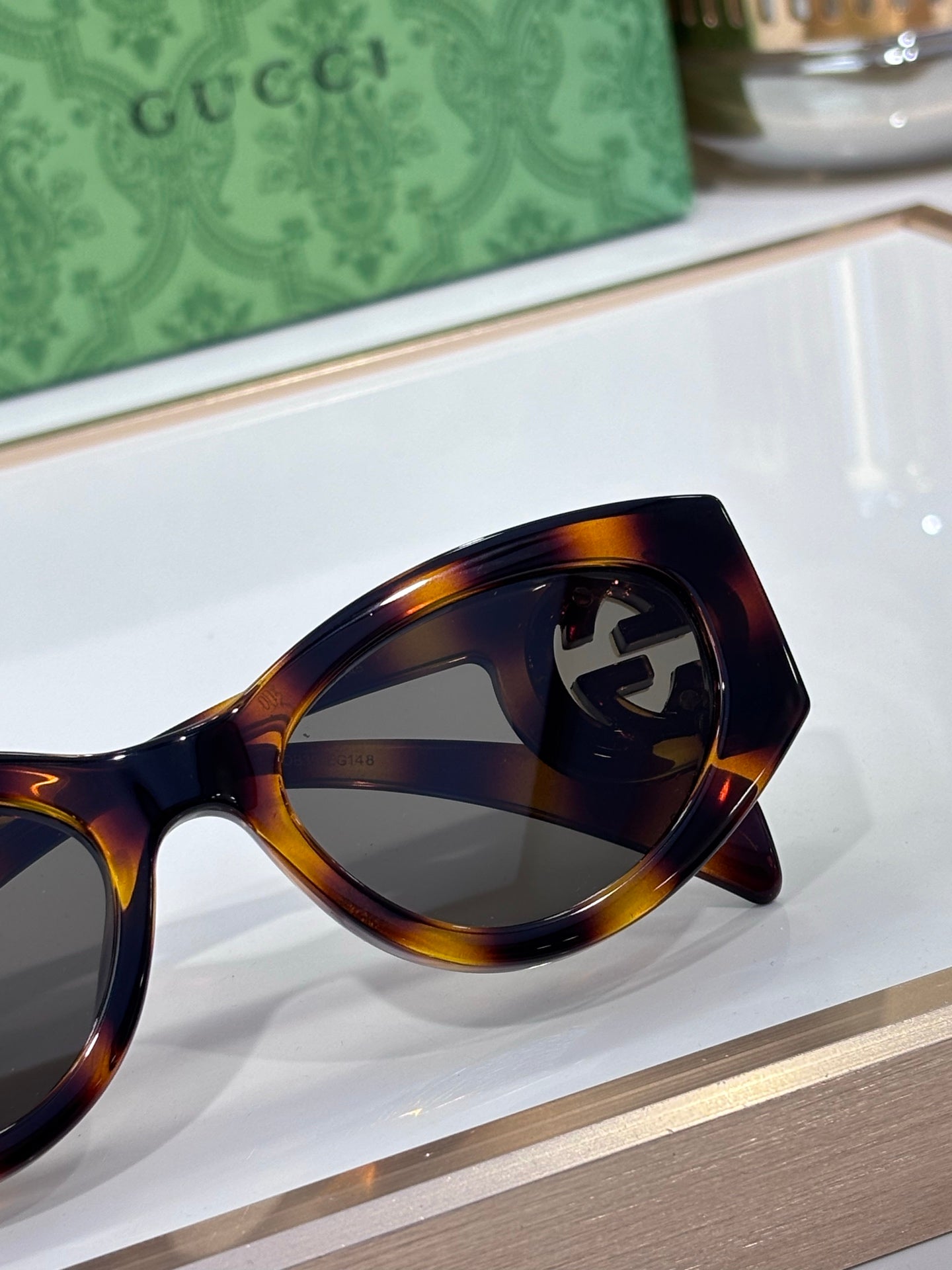 Gucci tortoiseshell sunglasses close-up on lenses and frame curve