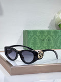 Gucci sunglasses with black frame and dark lenses, logo detail at the hinge