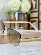 Metal oval sunglasses with gradient lenses and textured gold temple arm detail