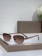 Metal-framed oval sunglasses with brown lenses and gold textured temple arms