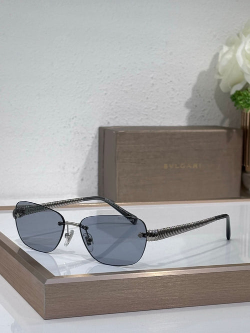 Metal-framed oval sunglasses with blue lenses and textured gold temples