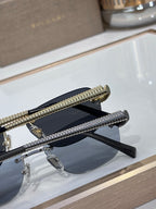 Pair of oval sunglasses on display with blue lenses and textured gold temple arms