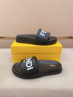 Black slip-on slide sandal with wide strap and raised FENDI logo patch on top.