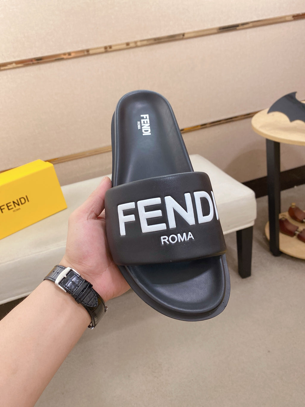 Navy slide sandal with wide strap showing FENDI ROMA text on the upper.