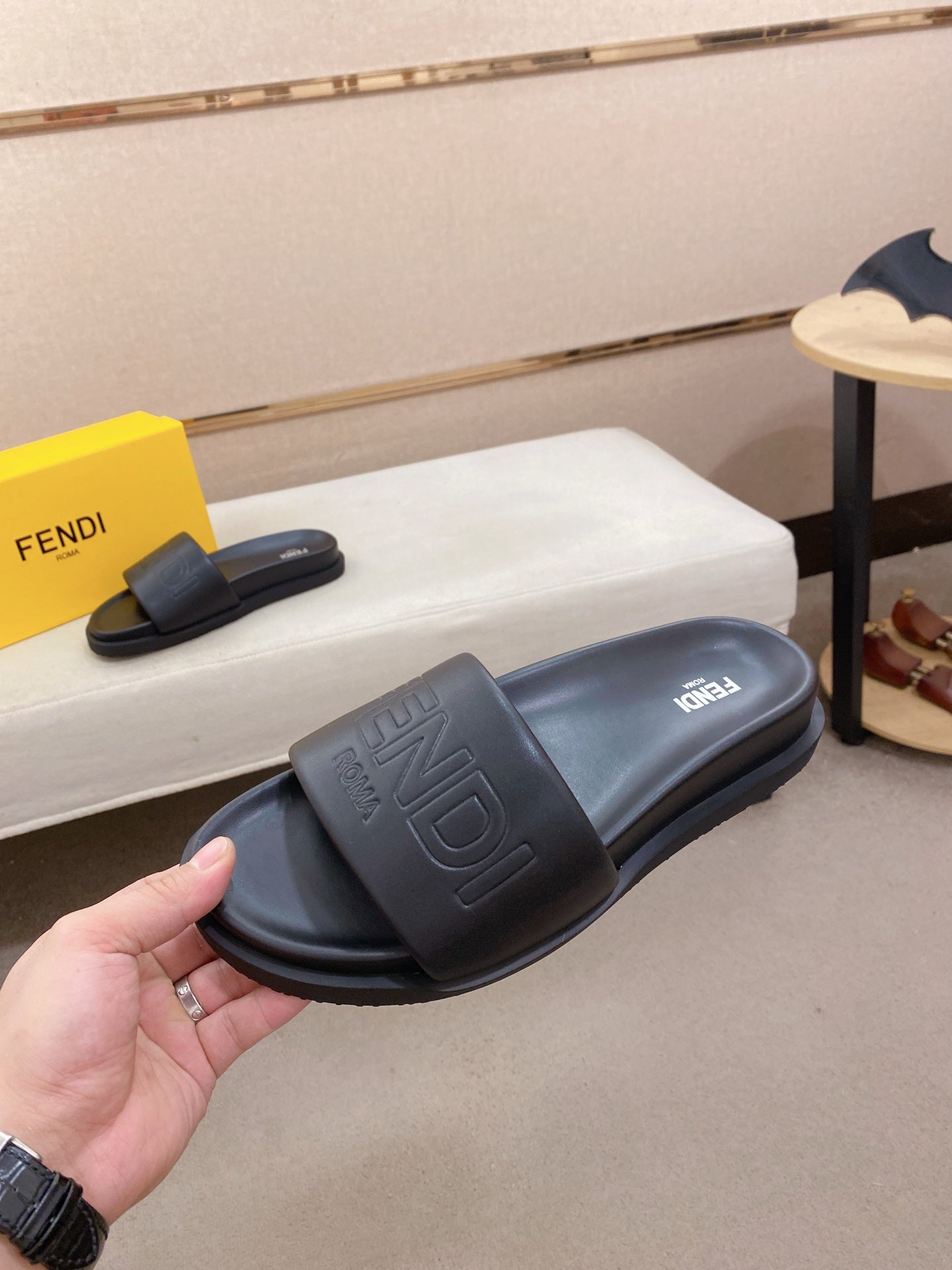 Fendi slide sandals in dark blue, side view with embossed FF logo on strap