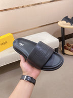 Fendi slide sandals in dark blue with embossed Fendi logo on upper