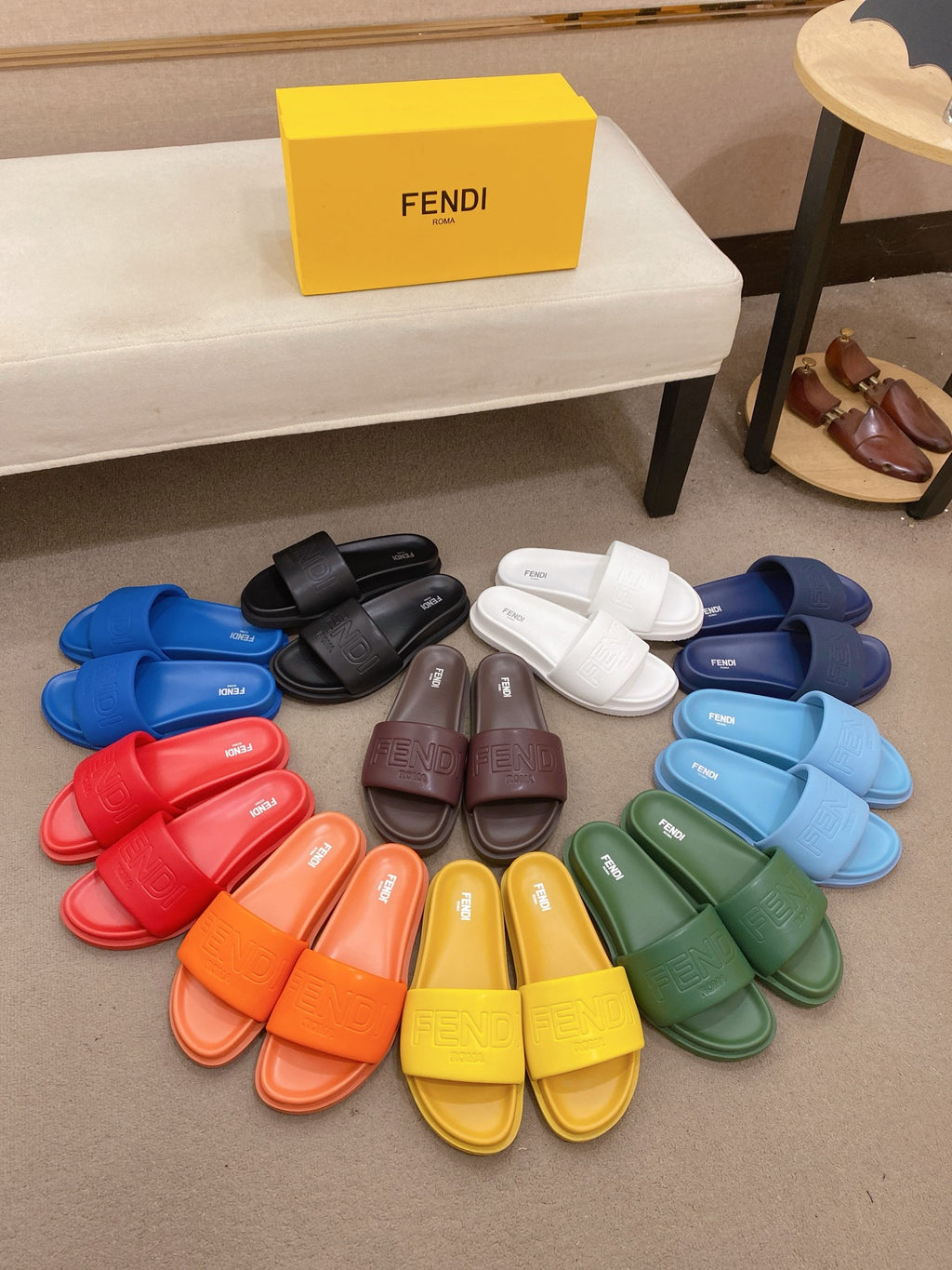 Assorted color slide sandals, including red, orange, yellow, green, blue, and black pairs