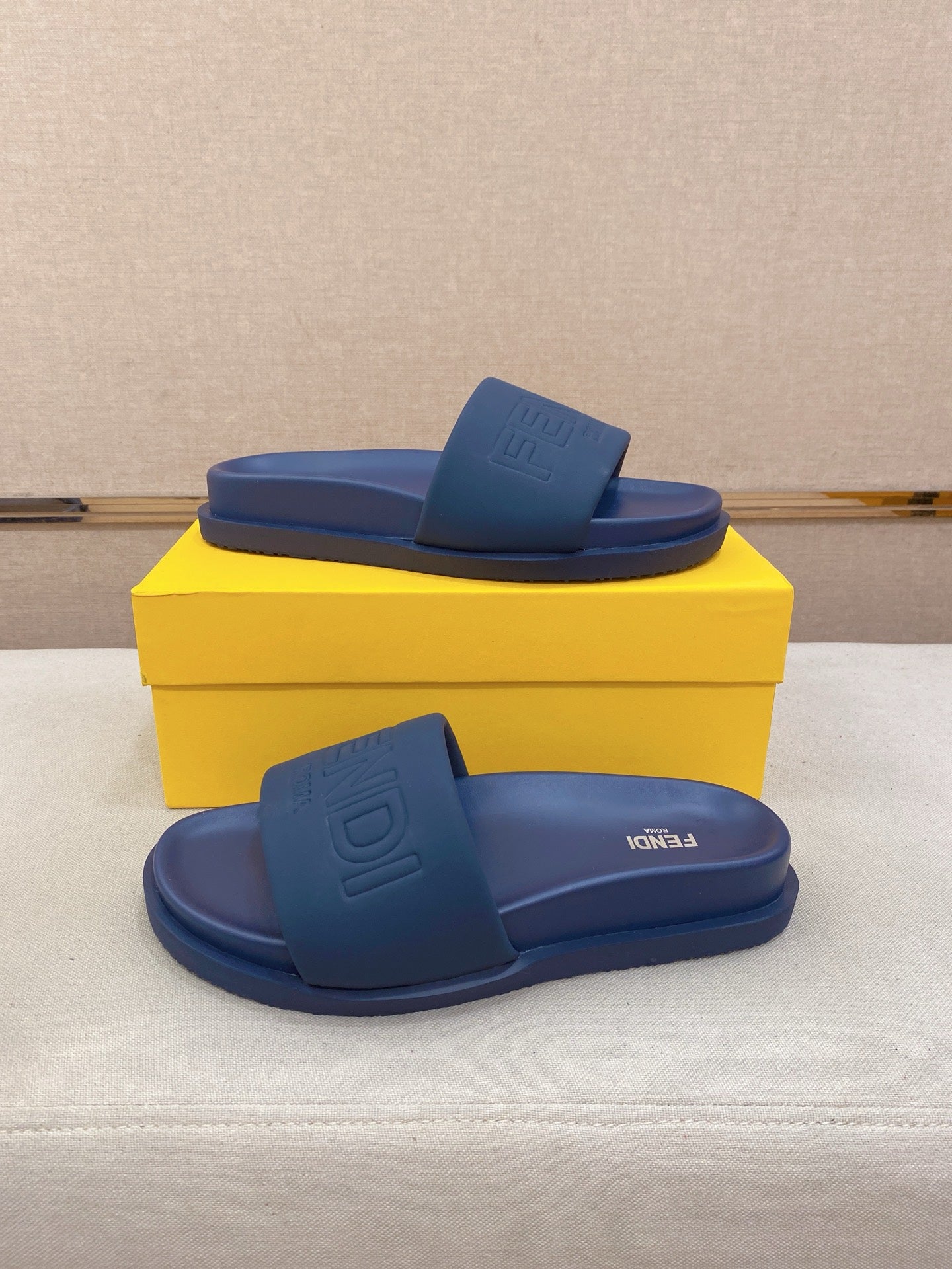 Fendi slide sandals, blue, front and side views with embossed FENDI logo