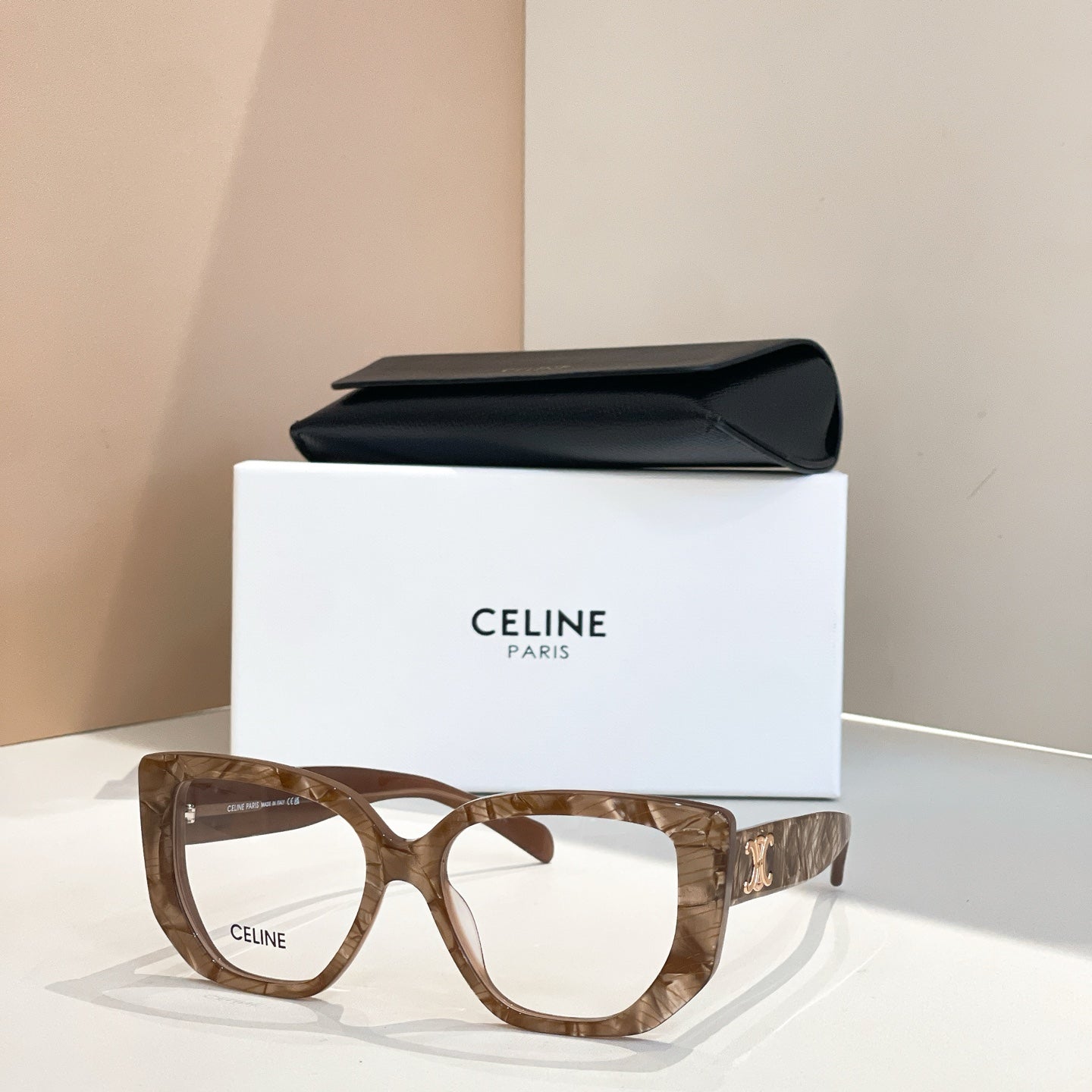 Celine glasses with brown square frames and gold logo on the temples
