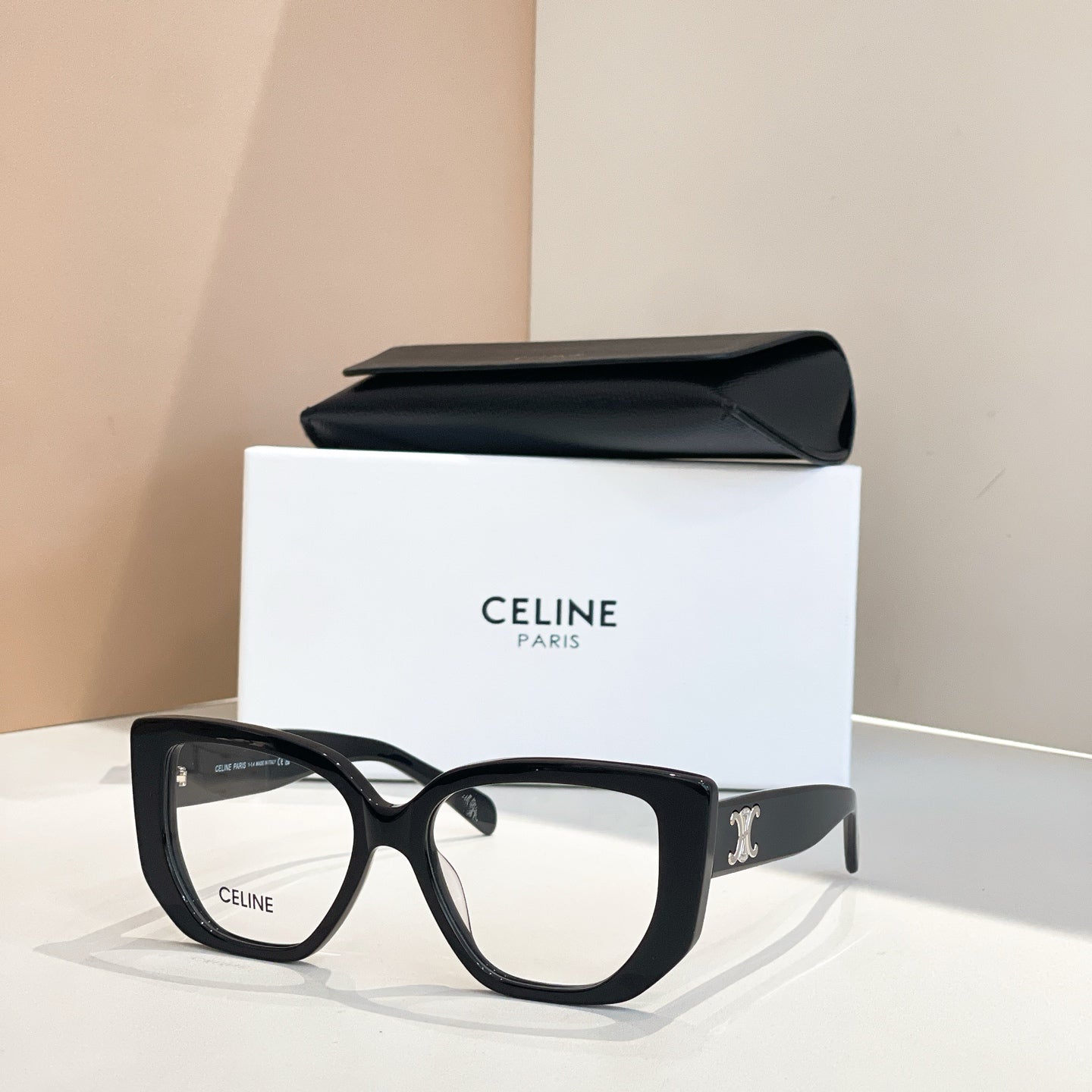 Celine glasses with black square frames and gold logo on the temples