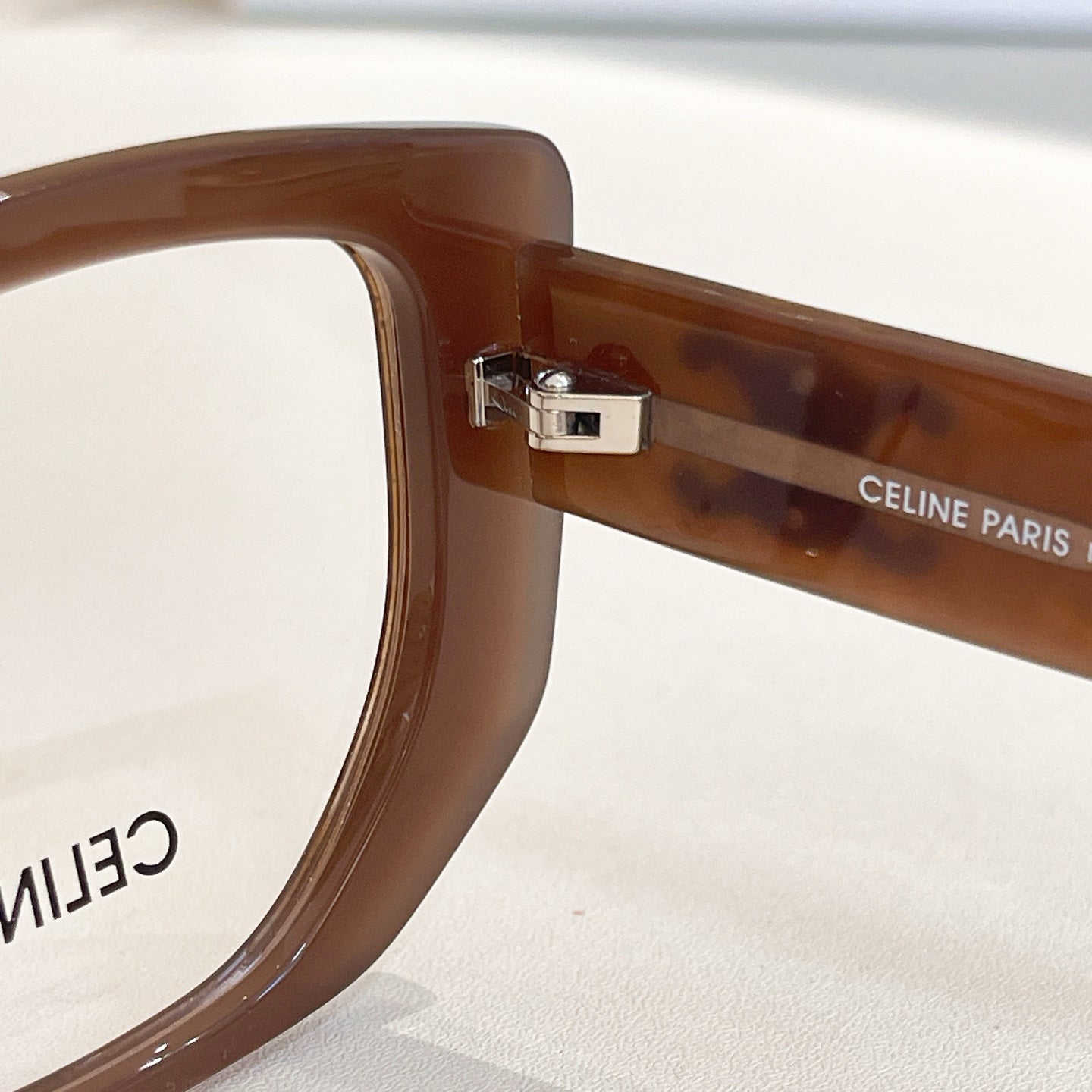 Brown eyeglass frame with metal hinge and CELINE PARIS engraving