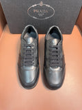 Dark leather lace-up sneakers with Prada logo, low-top design.