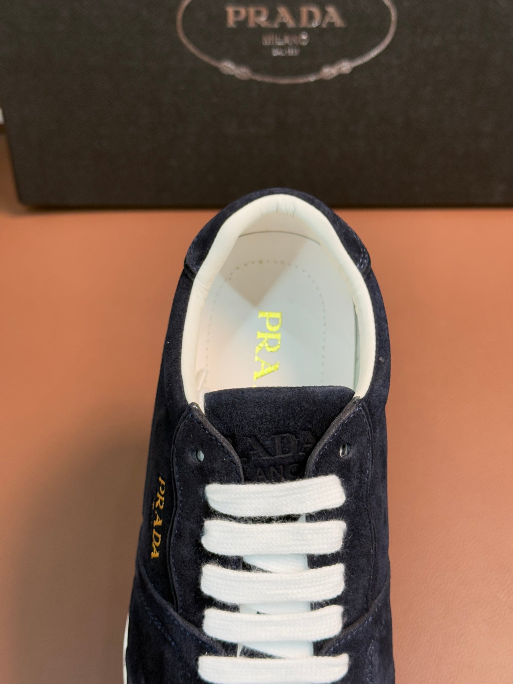 Prada unisex sneakers, navy suede with white lace trim and PRADA logo on tongue