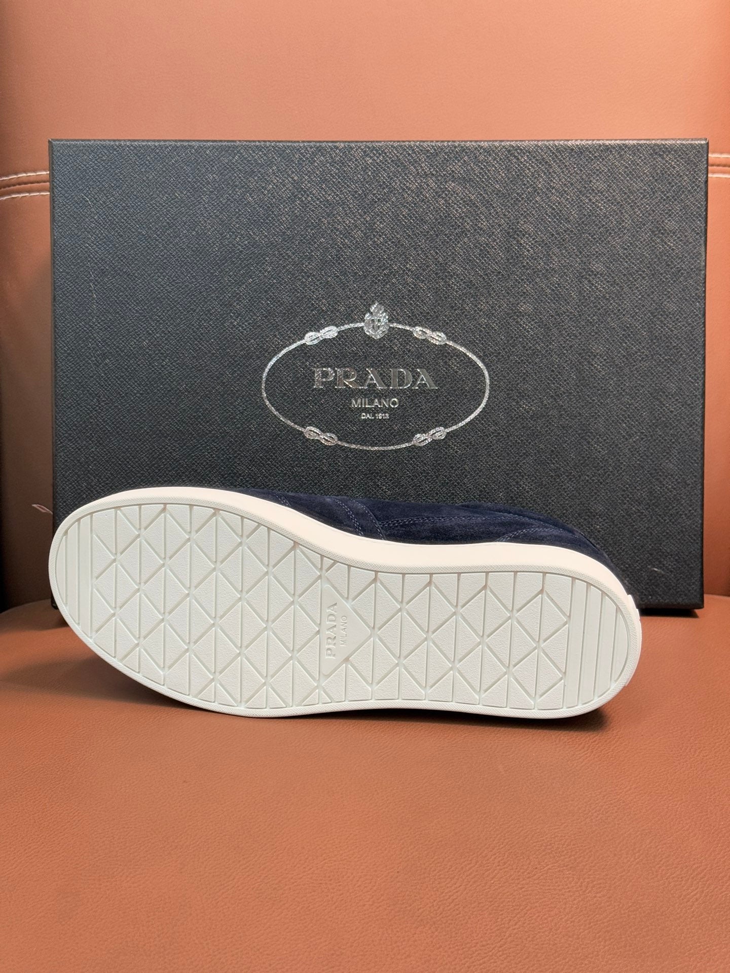 Prada unisex sneakers outsole, textured off-white rubber tread under navy upper