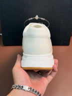 Prada unisex white sneakers heel close-up with gum sole edge
